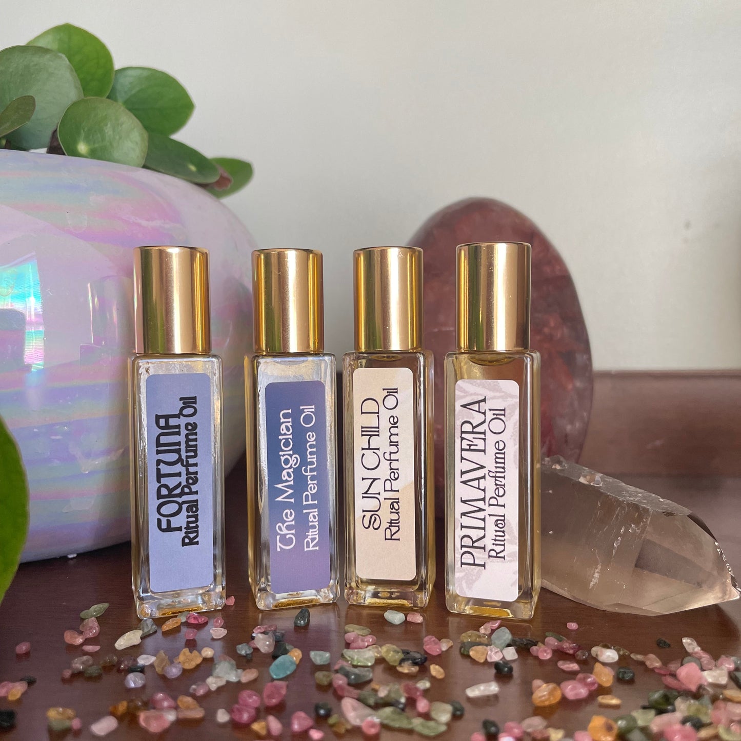 Set of small bottles with gold caps and labels on a decorative background