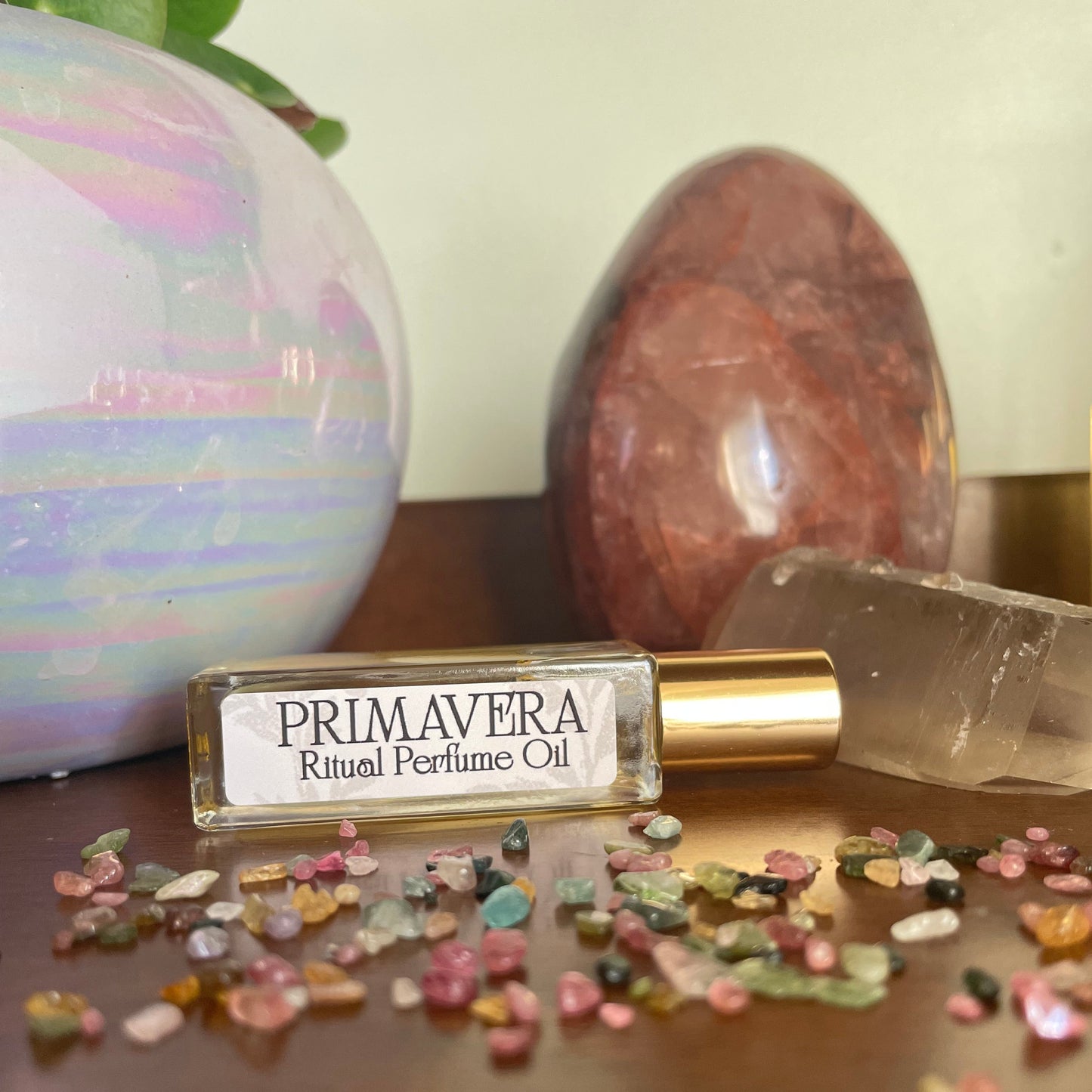 Perfume bottle labeled 'Primavera' with decorative elements on a neutral background