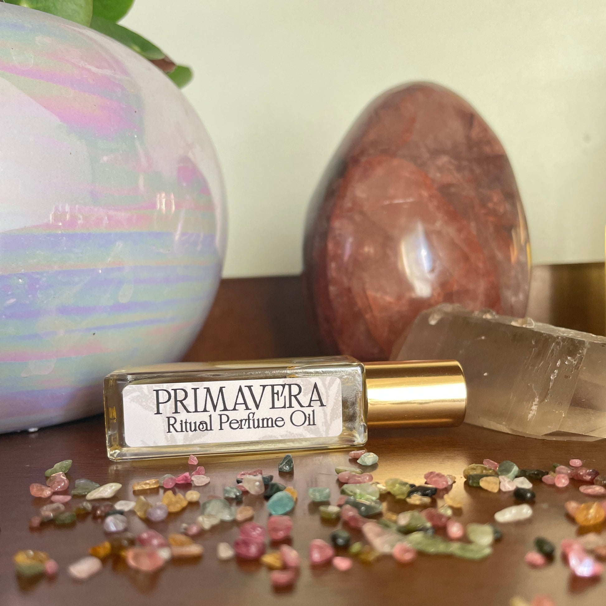 Perfume bottle labeled 'Primavera' with decorative elements on a neutral background