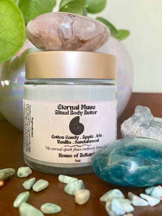 Jar of Eternal Muse Ritual Body Butter with decorative stones and crystals on a wooden surface
